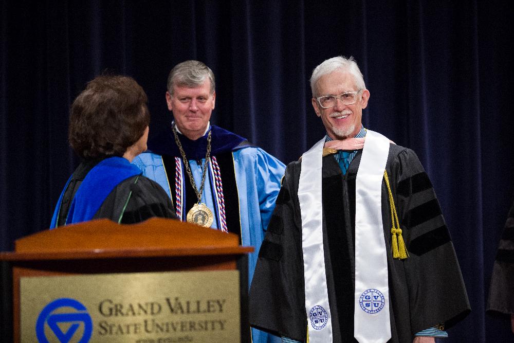 Former provost Davis and President Emeritus Haas congratulate faculty member awardee